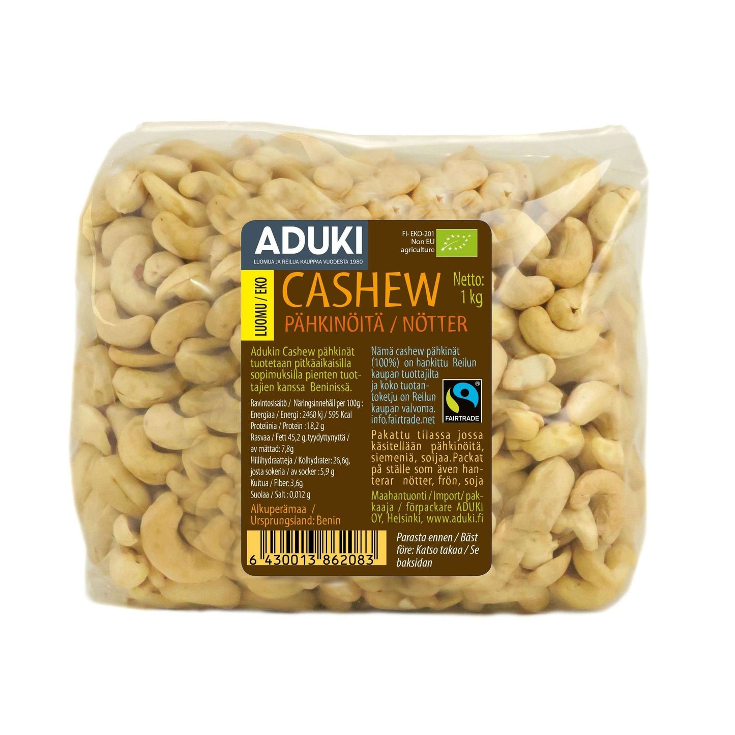 A clear plastic package of Aduki brand cashew nuts, labeled in Finnish and Swedish, showing 1kg net weight and displaying organic cashews inside. The packaging is rectangular with rounded edges and has a matte label featuring simple sans-serif font. A visible barcode appears at the bottom. The background is plain white. No people or hands are present in the image.