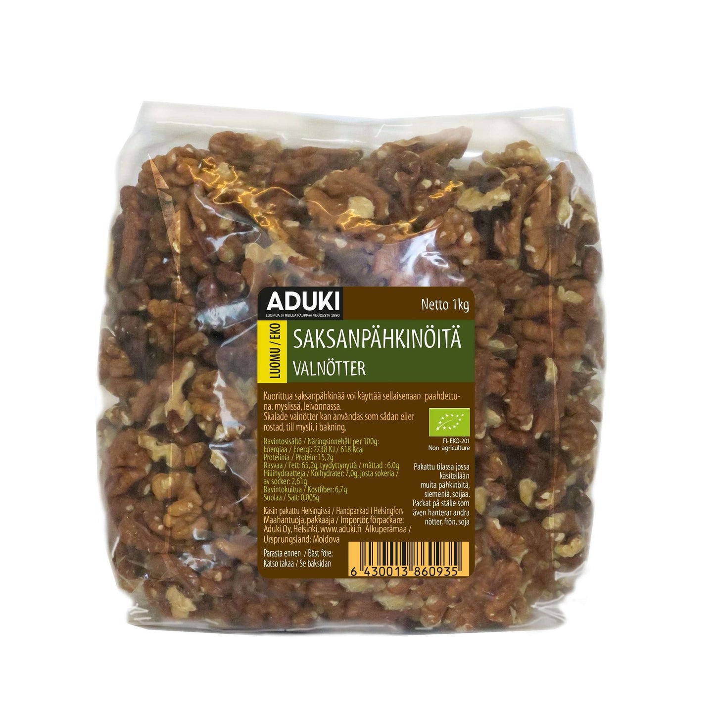 Aduki Luomu Saksanpähkinä -pussi, kirkas muovi, 1 kg saksanpähkinöitä, vihreä etiketti suomeksi ja ruotsiksi; lihavoitu groteskiteksti "ADUKI", pienempää tekstiä ainesosista alla