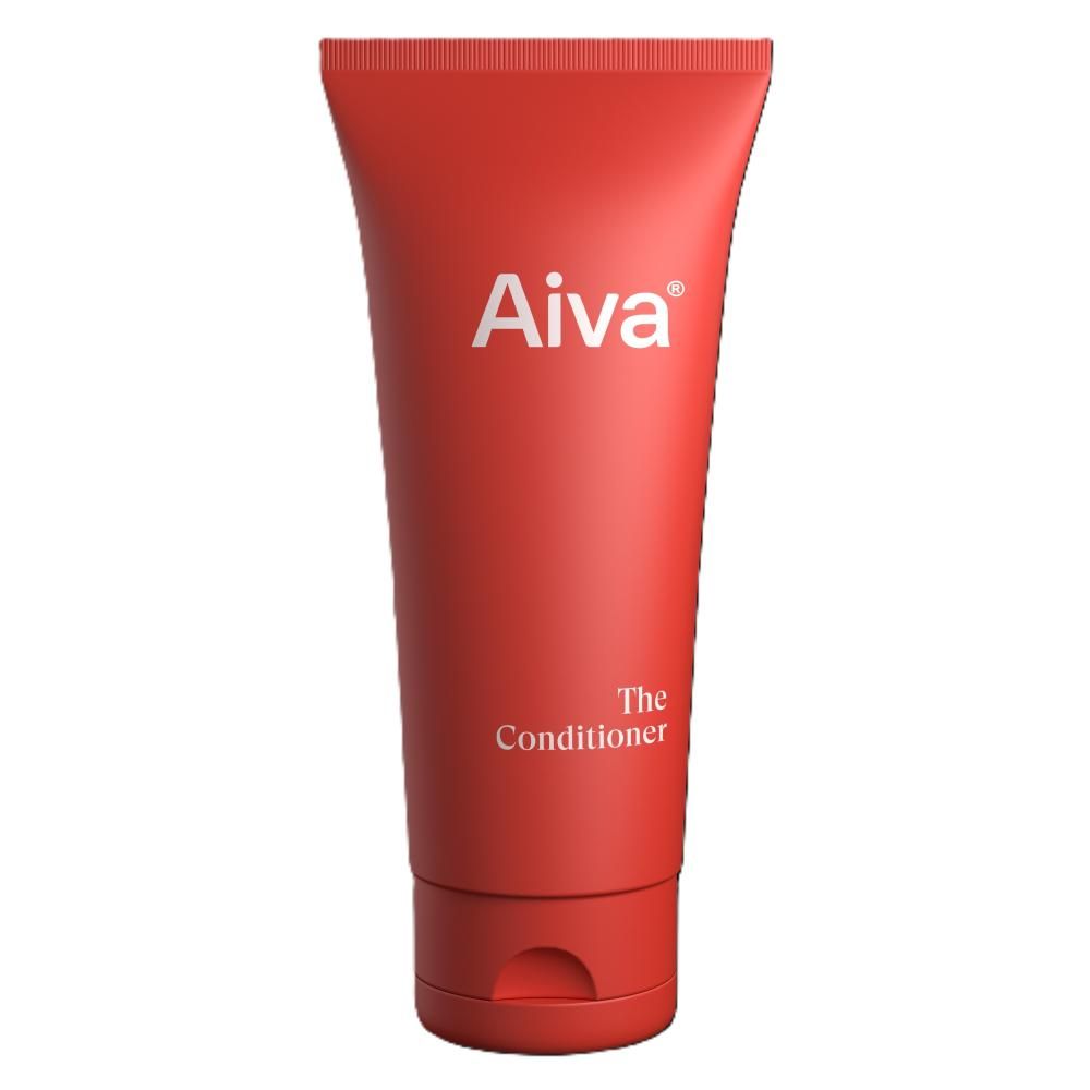 AIVA The Conditioner, a red plastic tube with a flip-top cap, is shown standing upright. The packaging is smooth and cylindrical. Legible label text reads: “AIVA The Conditioner Nourishing Care Formula.” The product is photographed on a plain white background. No people, hands, or props are visible in the image.