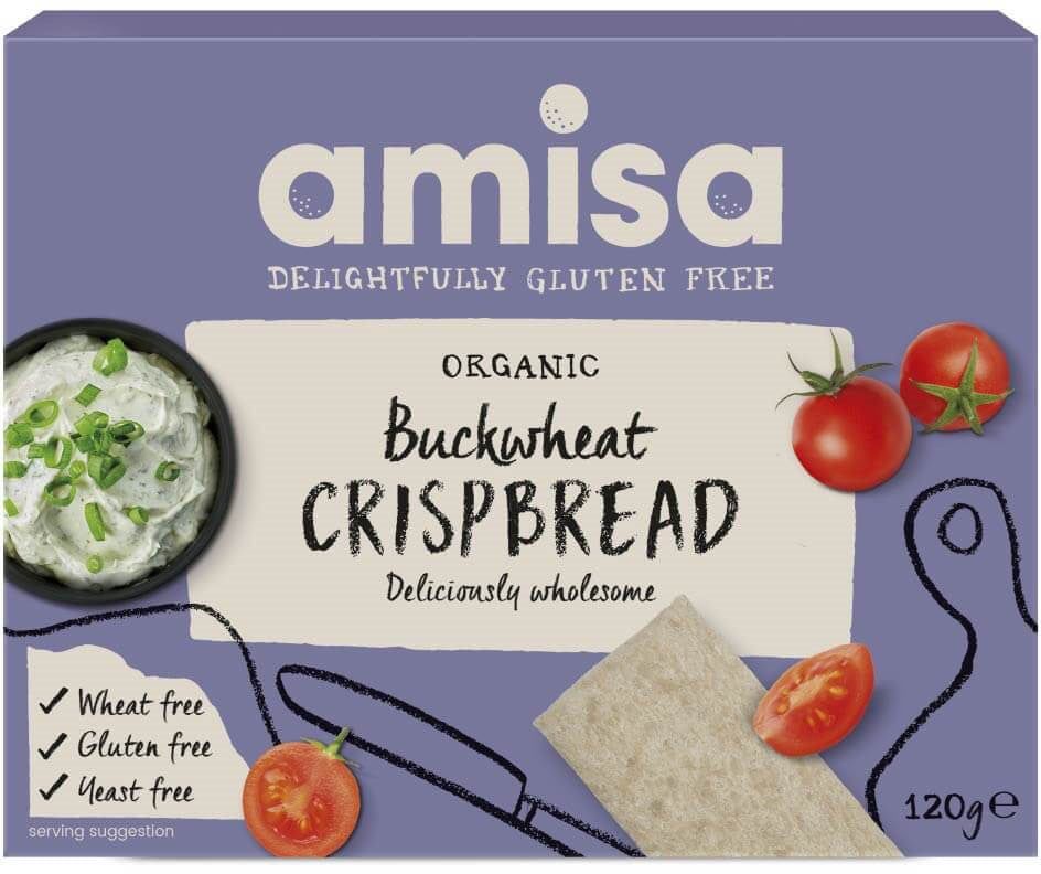 Box of Amisa Organic Buckwheat Crispbread, labeled gluten, wheat, and yeast free, with images of crispbread and tomatoes next to a dip on a light purple background. Features organic ingredients. Net weight 120g. The box has a matte finish with bold sans-serif and serif typography in white and green; no people or hands visible; standard product photo on plain surface.