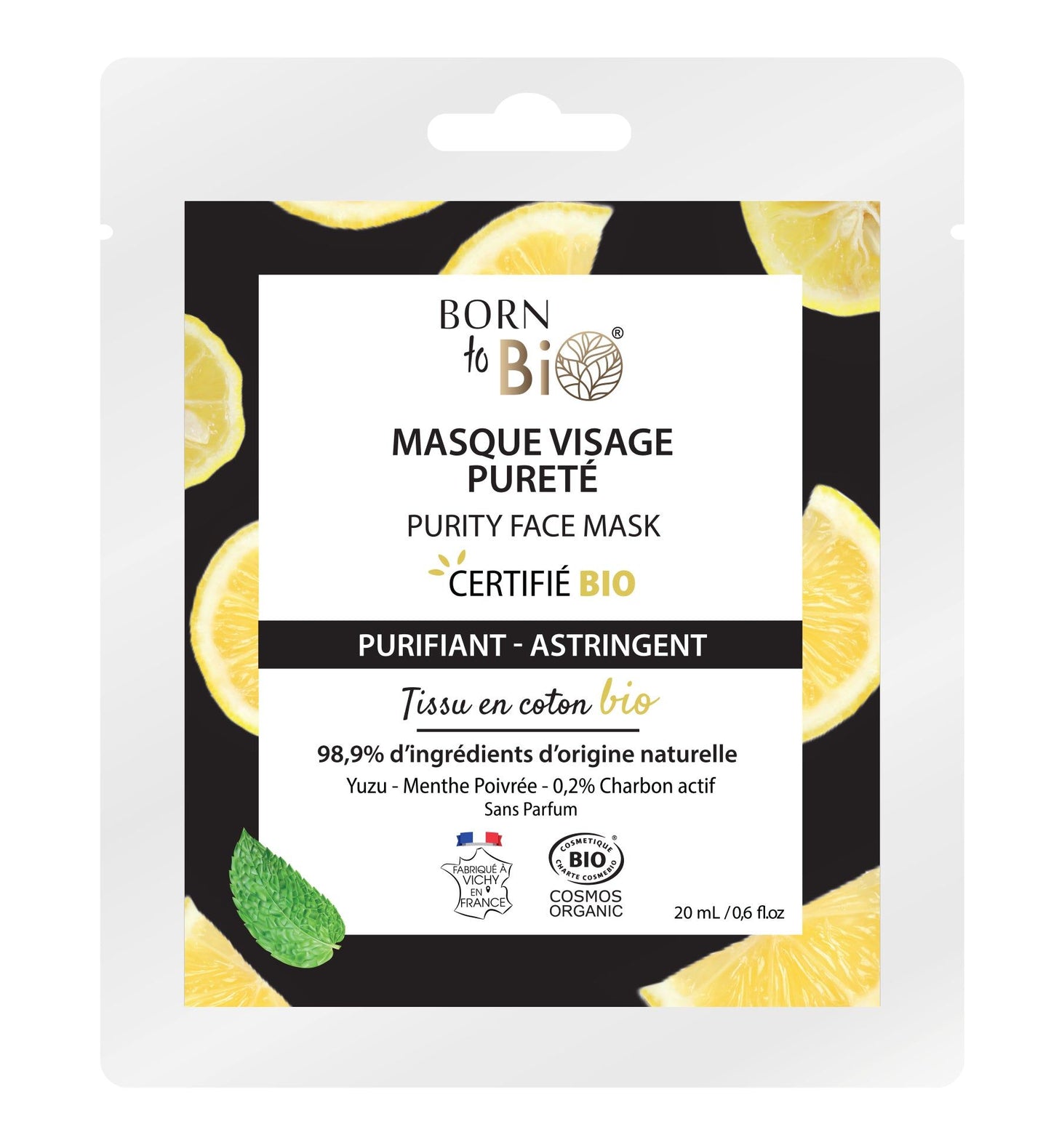 A package of Born to Bio Purity Face Mask with lemon slices and a mint leaf on a black background. The flexible pouch packaging is matte white with green accents and rounded corners. Simple sans-serif typography is used for the brand name and product details. Visible text includes organic certification indicators and lists natural ingredients. No people or hands are present in the image.