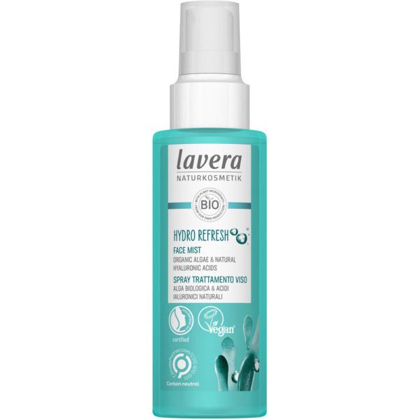A turquoise plastic bottle labeled “Lavera Hydro Refresh Face Mist,” cylindrical with a clear cap, matte finish. White sans-serif text lists organic algae and hyaluronic acids. Circular vegan and eco-friendly icons are on the label. No people or hands visible. Plain white background, studio lighting, straight-on product shot.