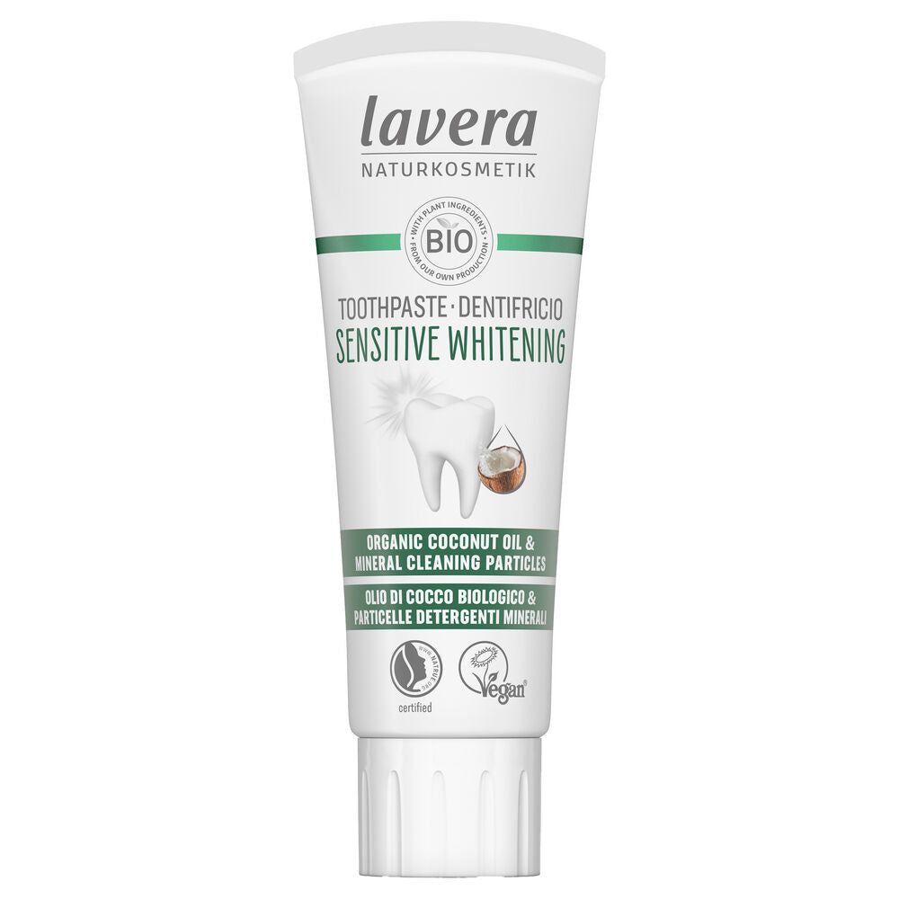 Tube of Lavera Sensitive Whitening toothpaste with coconut oil, mineral cleaning particles, and vegan certification, displayed on a white background. The tube is white with a matte finish and has a flip-top cap. The label features images of a tooth and a coconut alongside product text in sans-serif font. No people or hands are visible in the image.