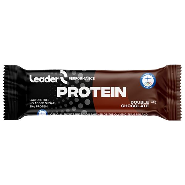 A Leader Performance Protein bar, double chocolate flavor, in a brown and black glossy wrapper with white and gold bold sans-serif text. The packaging displays “20g protein,” “lactose free,” “no added sugar,” and the Olympic Team Finland logo. Product is rectangular and sealed. Neutral background; no people or other objects visible.