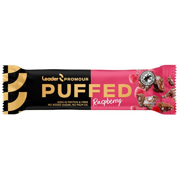 A raspberry-flavored PUFFED snack bar in a black and pink wrapper, labeled Leader Promour. Wrapper is matte with bold, block-style white and pink text; high protein, fiber, no added sugar, and no palm oil claims prominently printed. Rectangular packaging with sealed edges. No people visible. Neutral background; standard product shot layout.