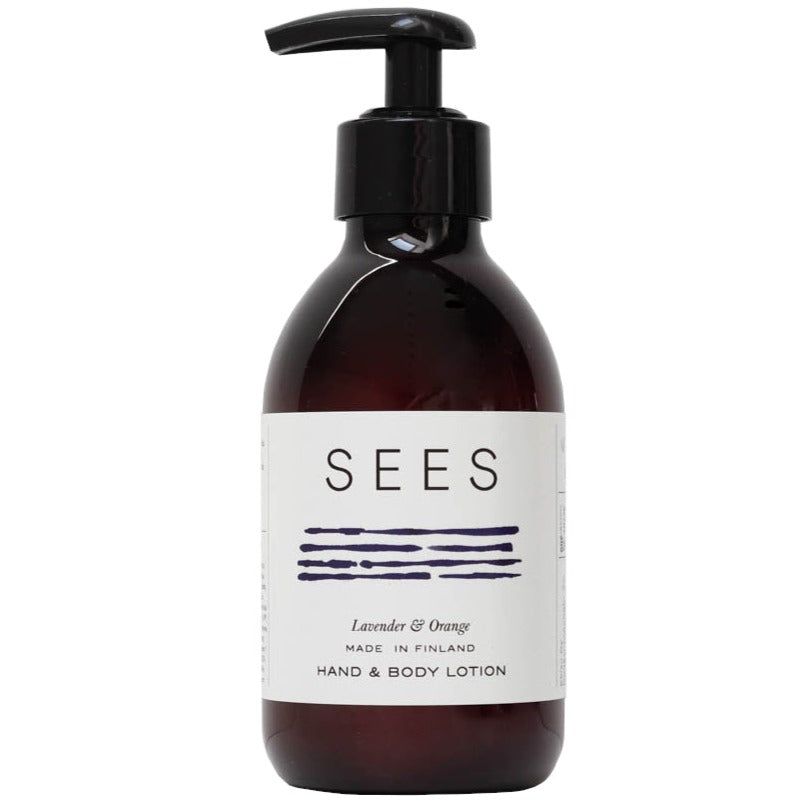 A brown plastic pump bottle with a matte finish features a white rectangular label. The label displays the brand name “SEES” in large, condensed navy blue uppercase letters, with several horizontal navy blue lines. Smaller text reads “Lavender & Orange,” “Made in Finland,” and “Hand & Body Lotion.” No background, setting, people, or objects are visible.