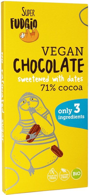 A yellow Super Fudgio vegan chocolate bar featuring a playful illustration of a sloth eating dates. The wrapper is matte and rectangular, with bold sans-serif typography for the product name and claims. Icons indicate gluten-free, palm oil–free, and organic. Key label text: 71% cocoa, sweetened exclusively with dates, crafted from only 3 ingredients. No people or background visible in the shot.