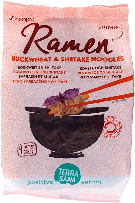 A package of TerraSana Ramen Buckwheat & Shiitake Noodles, featuring a black bowl with chopsticks holding noodles. The front shows matte finish packaging with a photo of the dish. Text includes “gluten-free,” “organic,” and “4 ramen cakes made with buckwheat.” Sans-serif font is used. No people or hands visible. White background, product-centered shot.