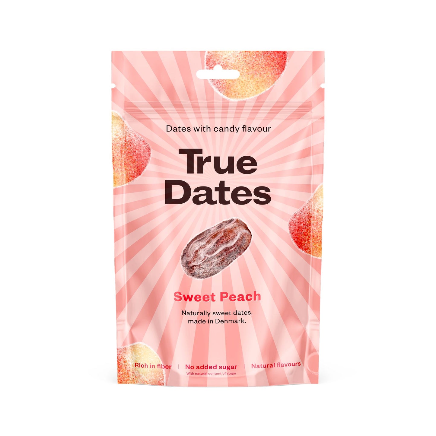 A pink resealable pouch labeled True Dates Sweet Peach features images of sugared peach slices and a date fruit. The packaging highlights include dates with a candy flavour, no added sugar, rich in fiber, and natural flavours. Matte finish on flexible plastic. Upright standing package with product information printed on front in clear sans-serif type. Solid white background, no people or props visible, centered front-facing shot.