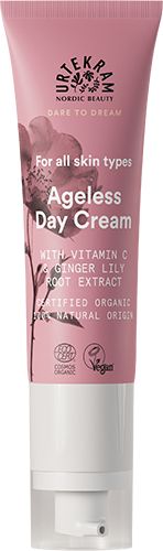 A tube of Urtekram Ageless Day Cream with Vitamin C and ginger lily root extract, labeled for all skin types, organic, vegan, with 99% natural origin ingredients. The pink and white package features floral graphics. Tube is upright with a matte finish; label text uses simple sans serif fonts in white and pink. Product is photographed against a plain light background; no people or hands are visible.