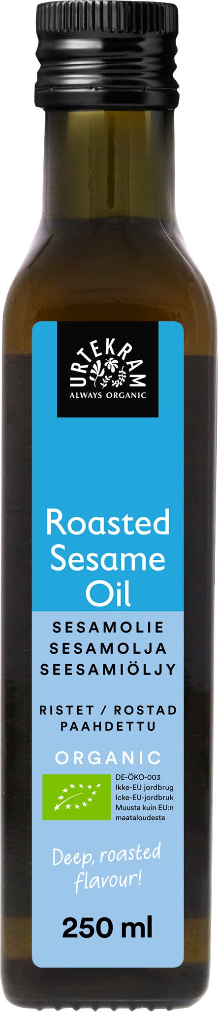 A bottle of organic roasted sesame oil with a blue label displaying the product name in multiple languages and a volume of 250 ml, highlighting its premium quality. The bottle is cylindrical, made of dark glass with a matte finish, and has a screw cap. The blue label has white sans-serif text and minimal graphic elements. The background is plain white with no people or hands visible. This is a front-facing product shot.
