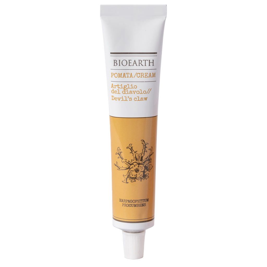 A tube of Bioearth Devils Claw cream with a white cap, yellow and white label, and botanical illustration on the front features natural botanicals. Tube is upright with a smooth, matte finish; label has black sans-serif text and colored botanical drawing; most visible text reads “Bioearth Devils Claw.” Background is plain white; no people or additional objects are present.