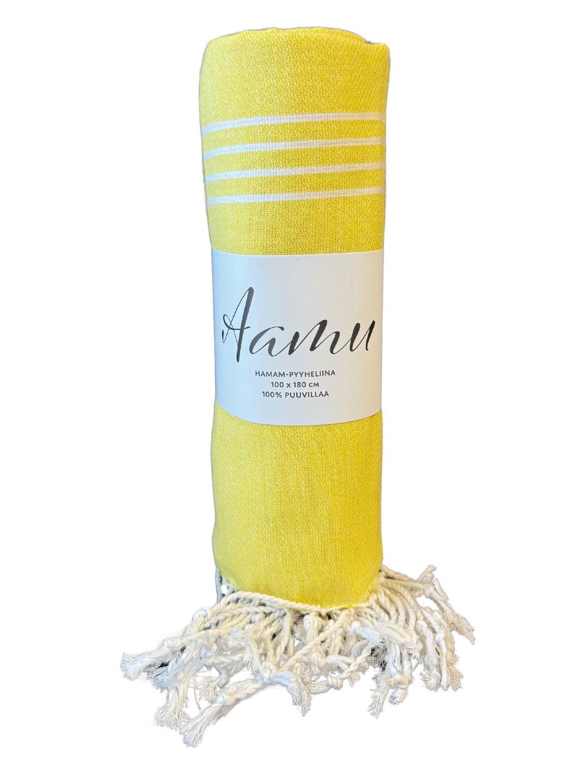 A rolled yellow towel with white stripes and fringed ends, wrapped in a white cotton label that reads Aanu. The towel is cylindrical, made from textured fabric, and has a matte finish. The label features simple black sans-serif text. The photo background is plain white with no other objects or people visible.