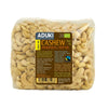 A clear plastic package of Aduki brand cashew nuts, labeled in Finnish and Swedish, showing 1kg net weight and displaying organic cashews inside. The packaging is rectangular with rounded edges and has a matte label featuring simple sans-serif font. A visible barcode appears at the bottom. The background is plain white. No people or hands are present in the image.