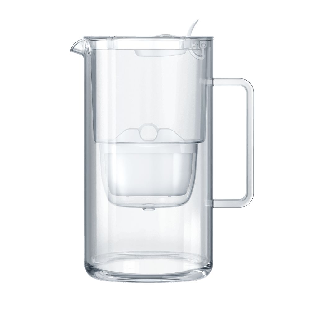 A clear plastic water pitcher with a built-in filter, ergonomic handle, and secure lid, shown on a plain white background. The transparent body reveals the internal filter component; surface finish is glossy. The curved handle is molded into the side. No label text or branding is visible. No packaging or additional items present, shot is at eye level with no people or hands included.