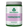 A green and white jar labeled BIOTEEKKI KARNOSIINI with a purple band, containing 60 capsules. The plastic container has a matte finish, cylindrical shape, and a screw cap. The label uses bold sans-serif text with block lettering in different font weights. Main label text includes AMINOHAPPO, PITKÄVAIKUTTEINEN, and HELPPOSTI NIELTÄVÄ amino acid formula. The product is photographed against a plain white background; no people or actions are present.