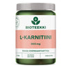 Bioteekki L-Karnitiini; vihreä-vaaleanpunainen muovipullo mattapinnalla, lieriön muotoinen kierrekorkillinen; etiketti pääosin valkoinen lihavoidulla sans-serif-typografialla mustana ja magentanpunaisena; luettavissa "Bioteekki L-Karnitiini 300 mg" ja 90 tablettia; ei ihmisiä tai käsiä; tuote kuvattu tasaista valkoista taustaa vasten.