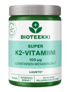 Bioteekki Super K2-vitamiini -pullo, 100 mikrog, vihreä-valkoinen sylinterinmuotoinen muovi, valkoinen kierrekorkki, mattapinta; lehtikuvake tuotenimen yläpuolella, suomenkielinen groteskiteksti, 60 kapselia