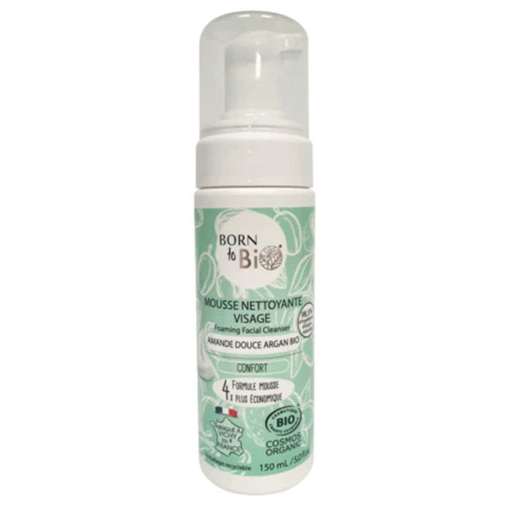 A bottle of Born to Bio Foaming Facial Cleanser with organic sweet almond and argan oil, featuring a white plastic pump dispenser and cylindrical shape. The green label is matte, with white bold sans-serif text and detailed botanical drawings. Product title and key ingredients are legible. The product is shown against a plain background.