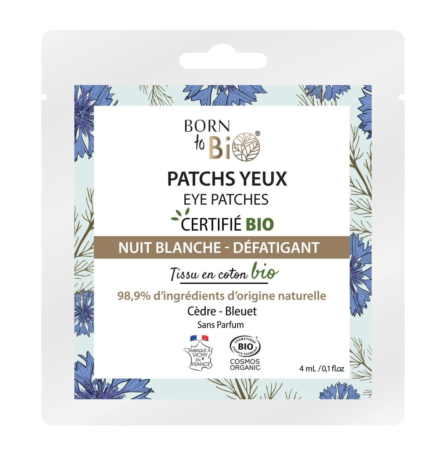 Square package of Born to Bio eye patches featuring blue and purple flowers, green and brown text, and a white background. Packaging is matte. Notable labeling includes icons for organic certification, 98.9% natural ingredients, eco-friendly details; label text is sans-serif. Product is photographed front-on against a solid white setting with no people or hands visible in the image.