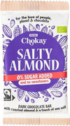 Chokay Luomu Tumma Suolainen Manteli Suklaa; Chokay Salty Almond -tumma suklaapatukka, 0 % lisättyä sokeria; violetti-valkoinen pakkaus kaakaopalkokuvituksin; kääre suorakaiteen muotoinen mattapinnalla; pääteksti lihavoituna groteskina, lisätiedot pienemmällä painatuksella; tuote tasaisella alustalla; ei ihmisiä tai käsiä kuvassa.