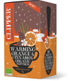 Clipper Luomu Appelsiini-Kaneliyrttitee; laatikko Clipper-luomuteelle, Warming Orange & Cinnamon -maku, kuvituksena teekuppi, appelsiiniviipaleita, kanelitankoja ja lumisen kylän maisema; suorakulmainen laatikko pääosin oranssi valko-mustin korostuksin ja mattapinnalla; antiikva- ja groteskifontteja pakkauksessa; etiketti mainitsee 20 pussia luomu-uutetta; ei ihmisiä tai käsiä, tasainen tausta.
