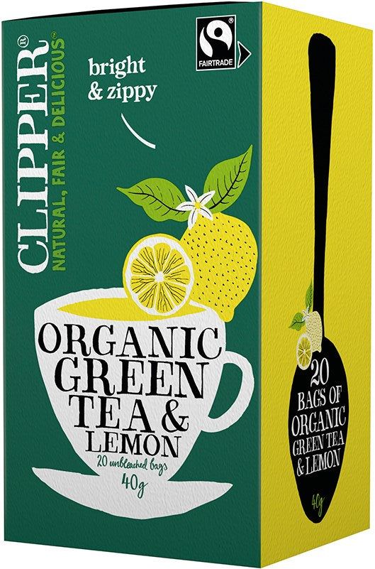 A green box of Clipper Organic Green Tea & Lemon, featuring a teacup with lemon slices and leaves, labeled as Fairtrade and organic, containing 20 unbleached tea bags. Rectangular matte cardboard packaging. Main label uses white sans-serif lettering on green. Logos for Fairtrade and organic certification visible. No background setting or people present, product centered in frame.