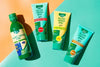 ESI Aloe Vera huulivoide SPF20; neljä ESI Aloe Vera -geelituotetta vihreä-oranssilla taustalla: yksi korkea, pyöreä pullo pyöristetyllä korkilla sekä kolme pystyssä olevaa, mattapintaista läppäkorkillista tuubia, joissa kirkkaanväriset etiketit tuotevarianttien nimillä.