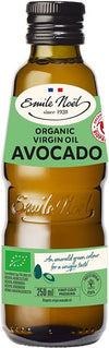 A bottle of Emile Noël Organic Virgin Avocado Oil stands upright, made of dark glass with a matte finish. The bottle has a green label with white and yellow text, displaying the brand name, product details, a red organic certification seal, and an illustration of a ripe avocado slice. No people or actions present. Plain white background. A bottle of Emile Noël Organic Virgin Avocado Oil, featuring a green label with product details, a red organic certification seal, and an illustration of a ripe avocado