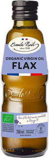 A brown glass bottle with a glossy finish, cylindrical shape, and screw cap. The label is matte with dark green and gold typographic elements, sans-serif and script fonts. Text reads: Emile Noël Organic Virgin Oil Flax, 250 ml, first cold pressed, with certifications and mention of Omega 3 source and organic. White background; no people or props visible.