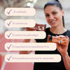 A smiling woman holds two snack bars. The bars are in matte, rectangular wrappers with clear printed labels. Overlay text in Finnish lists absence of certain sweeteners, sugars, palm oil, artificial flavors and colors. Sans-serif typeface is used for the overlay. The scene is set in an indoor sports hall.