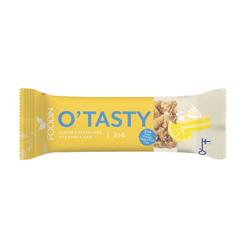 A yellow and white oat snack bar wrapper labeled FOODIN OTASTY Lemon Cheesecake Oat Snack Bar 25g, featuring images of oat clusters, a lemon slice, and creamy cheesecake. The wrapper is rectangular with a matte finish and crimped ends. Text is bold and capitalized in black on the front. No people or hands visible; the background is plain white with no additional props.