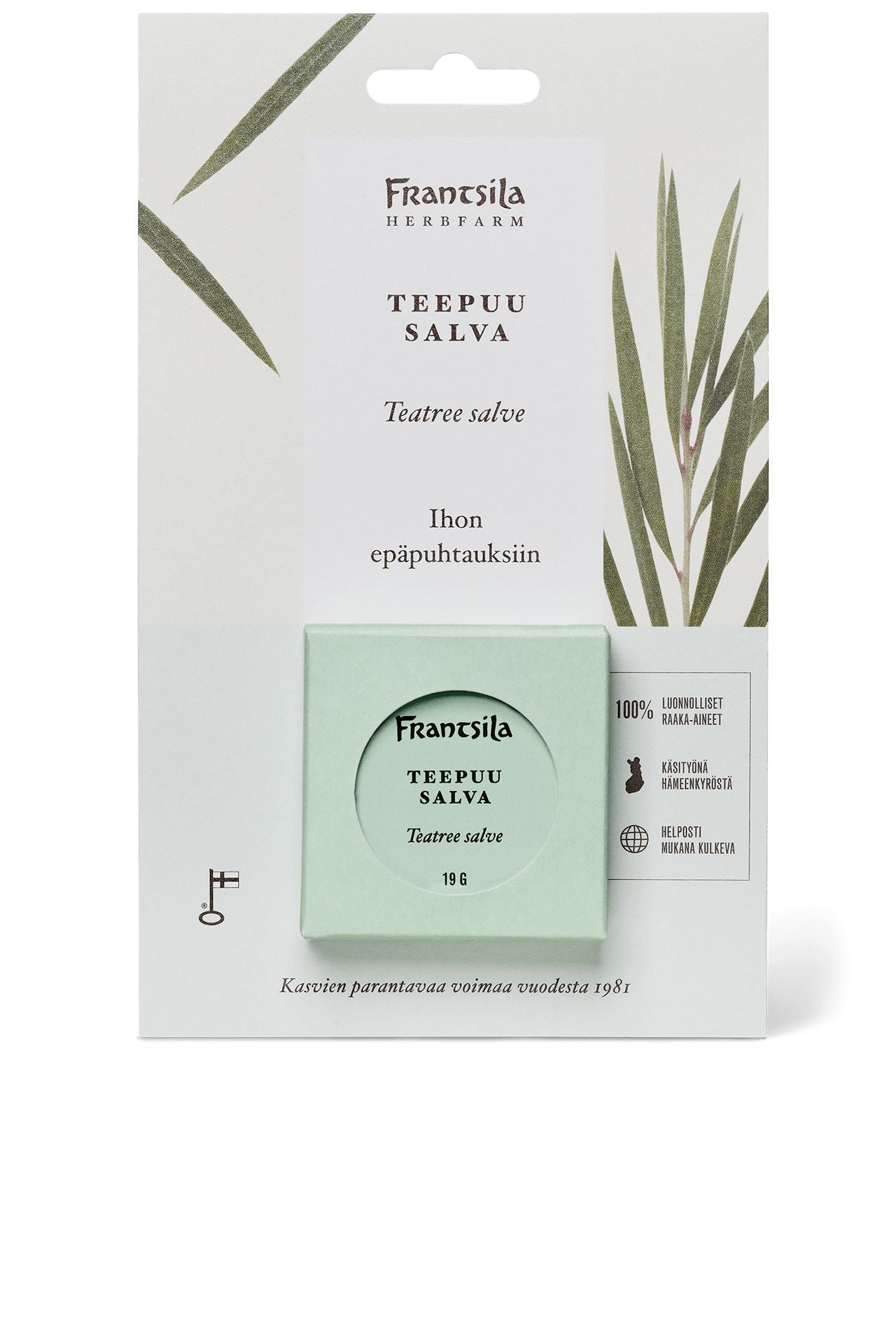 A package of Frantsila Teatree Salve, featuring a light green, round container with matte finish, decorated with small botanical illustrations and legible product information in both Finnish and English using simple sans serif fonts. The container is photographed against a plain white background without additional objects or people visible.
