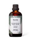 A brown bottle labeled Frantsila Herb Farm Refreshing Foot Bath with text in English and Finnish, featuring a green leaf design on the label and botanically inspired accents, set against a plain white background. The bottle is made of opaque brown material with a cylindrical shape and glossy finish. Label typography is clear, sans-serif for main product name, all legible. No people or additional objects in the image. The photo is taken head-on with even lighting.