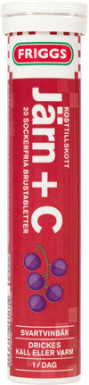 A red tube labeled FRIGGS Järn+C features images of purple currants on the packaging. The tube is cylindrical with a glossy surface and a white cap. The label uses bold, sans-serif typography in white and black against the red background. Product information text appears primarily in Swedish, including “20 brustabletter” and blackcurrant flavor references. No people or hands are present, and the product is photographed against a plain white background, shown upright in a clear product shot.