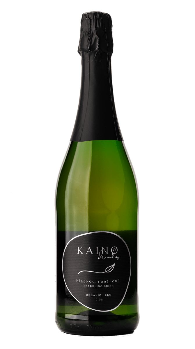A green bottle with a black foil top and a black label reading Kaino blackcurrant leaf sparkling drink, organic, is set against a white background. The bottle is cylindrical with smooth glass and a glossy finish. The label uses bold white sans-serif text on matte black. There are no people or additional objects visible in the shot; product is centered in the frame.
