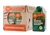 A cardboard box of six cartons and one single carton of Karin Havupuu-Uutejuoma, a Finnish pine extract drink, featuring natural green forest imagery and bright orange label accents. The packaging is rectangular with a matte finish; cartons have printed product name in clear sans serif type. All items rest on a plain surface background with no visible people or actions in the frame.
