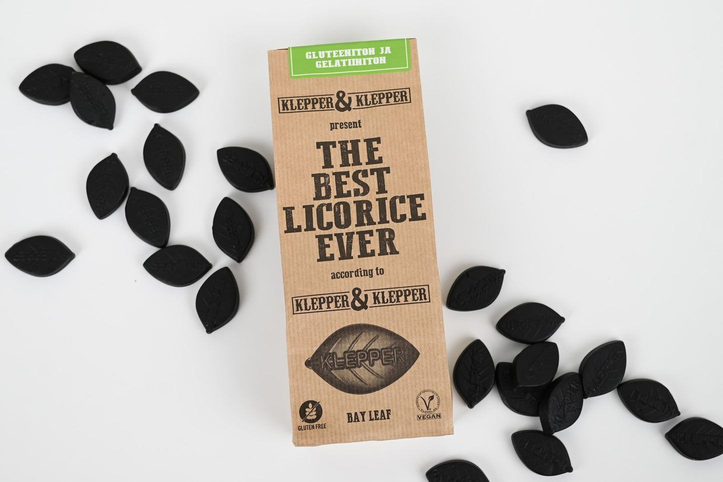 Klepper & Klepper Bay Leaf -lakritsipussi ylhäältä, ympärillä mustia lehdenmuotoisia lakritsipaloja