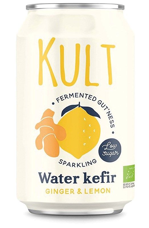 A can of Kult Water Kefir, ginger & lemon flavor. Cylindrical metal can with a glossy finish. The label is decorated with colorful illustrations of lemon and ginger. The background is plain and uncluttered. Sans-serif bold typography is used for the main text, which includes legible product name and key features. No people or hands in shot.