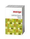 A rectangular box of morga Lakritsin lumo herbal drink with a white top section and a floral, green pattern at the bottom, featuring white flowers, small illustrated jars, and hints of licorice. Packaging has a matte finish. Main label text is in bold serif font. Photo shows only the product box against a plain background with no people or hands visible. Shot is clear and straight-on.