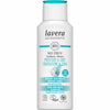A white plastic bottle of Lavera Basis Sensitiv conditioner for normal and dry hair, with a matte finish and rounded edges. The front label displays text about organic aloe vera, jojoba, vegan certification, organic status, and carbon-neutral claims using sans-serif fonts in blue and black. No people or hands are visible. Neutral background with simple lighting. A white bottle of Lavera Basis Sensitiv conditioner for normal and dry hair, featuring organic aloe vera and jojoba. The label highlights vegan,