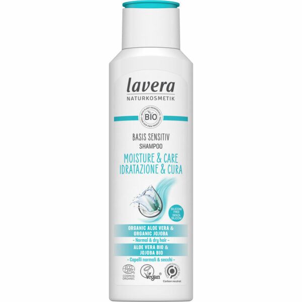 White bottle of Lavera Basis Sensitiv Shampoo for normal and dry hair, featuring blue accents and text highlighting moisture and care, with organic aloe vera and jojoba. Vegan and certified natural cosmetics logos shown, emphasizing gentle hydration with natural ingredients. The bottle is upright, plastic with a glossy finish, rounded edges, clear cap, sans-serif typography on label. Plain background. No people present.