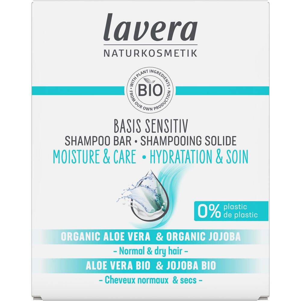 Lavera shampoo bar box with blue water splash, labeled Basis Sensitiv, Moisture & Care, Organic Aloe Vera & Jojoba Bio, for normal and dry hair—formulated with 0% plastic. Rectangular cardboard packaging is light blue and white with a matte finish. Sans-serif typographic hierarchy is used on the front. Product photo is clear with no people or objects in the background.