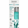 Box of lavera Hydro Refresh Serum with organic algae and hyaluronic acids. The carton is rectangular, mostly white with blue and green accents, matte finish. Vegan, certified, and carbon neutral logos are printed on the front. Sans-serif font used for main text. Part of the clear or frosted serum bottle is visible through a cutout in the packaging; no people or hands present. Plain background; product shot up close.