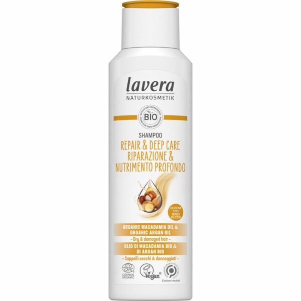 White bottle of Lavera Repair & Deep Care Shampoo with organic macadamia and argan oil, designed for dry and damaged hair. Plastic bottle with smooth matte finish, upright rectangular shape, rounded corners. Label displays English and Italian in a mix of bold and regular sans-serif fonts; several certification logos are lined up at the bottom. Single product centered against plain white background. No people or hands visible.