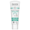 A white tube of Lavera Sensitive & Repair toothpaste with chamomile, labeled vegan and organic, featuring a tooth image and green-blue herbal accents. The packaging is plastic, has a matte surface, cylindrical shape with a flat cap. Text on the front includes product name and key features in sans-serif fonts. The background is plain white; no people or actions are present.