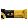 A yellow and black wrapper for Leader Promour Crispy Choco & Hazelnut protein bar, 45g. The packaging highlights high protein and fiber content, with no added sugar or palm oil. Hazelnut is featured as a key ingredient. The wrapper is glossy with bold sans-serif white and black text; icons emphasize product features. No people or hands visible, plain background, product centered in frame.
