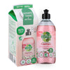 A bottle of Lumme apple blossom hand dish soap stands beside its refill box, featuring green and pink colors, images of flowers and apples, and Finnish text highlighting eco-friendly ingredients and efficient cleaning. Both items are rectangular with plastic caps on the bottle. Surfaces are matte. The packaging uses bold sans-serif fonts in white and dark green. The background is plain white with no people or hands visible. This is a studio product shot at eye level.