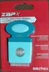 A packaged manual lice comb called ZapX by Magnien, featuring rounded teeth and a built-in magnifying glass for precise removal. The comb is visible through a clear plastic window in the packaging. The packaging is rectangular and red with a matte finish, includes multilingual text in white, yellow, and black fonts, and displays the Biosynex logo at the bottom. Plain white background, product shot only.