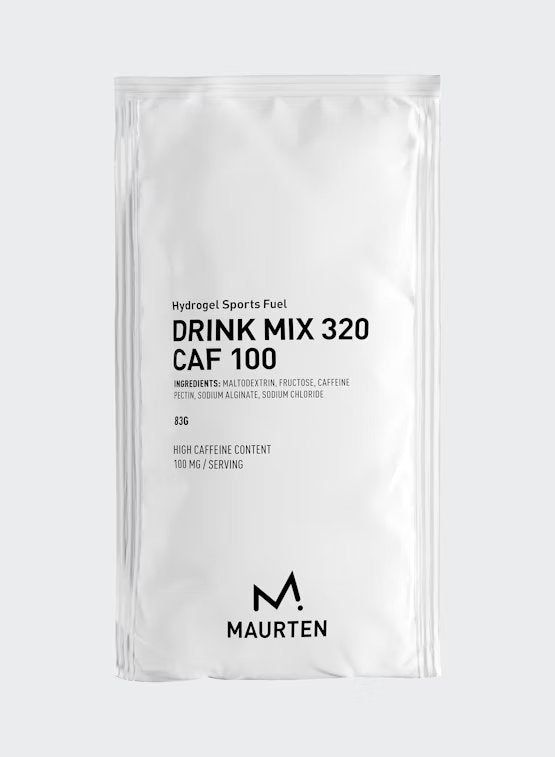 A white, rectangular matte packet stands upright against a plain background. Black sans-serif text reads “Maurten Drink Mix 320 Caf 100” with additional small-print ingredient and caffeine content details. The Maurten logo is positioned at the bottom of the package. No people or hands are present in the image.